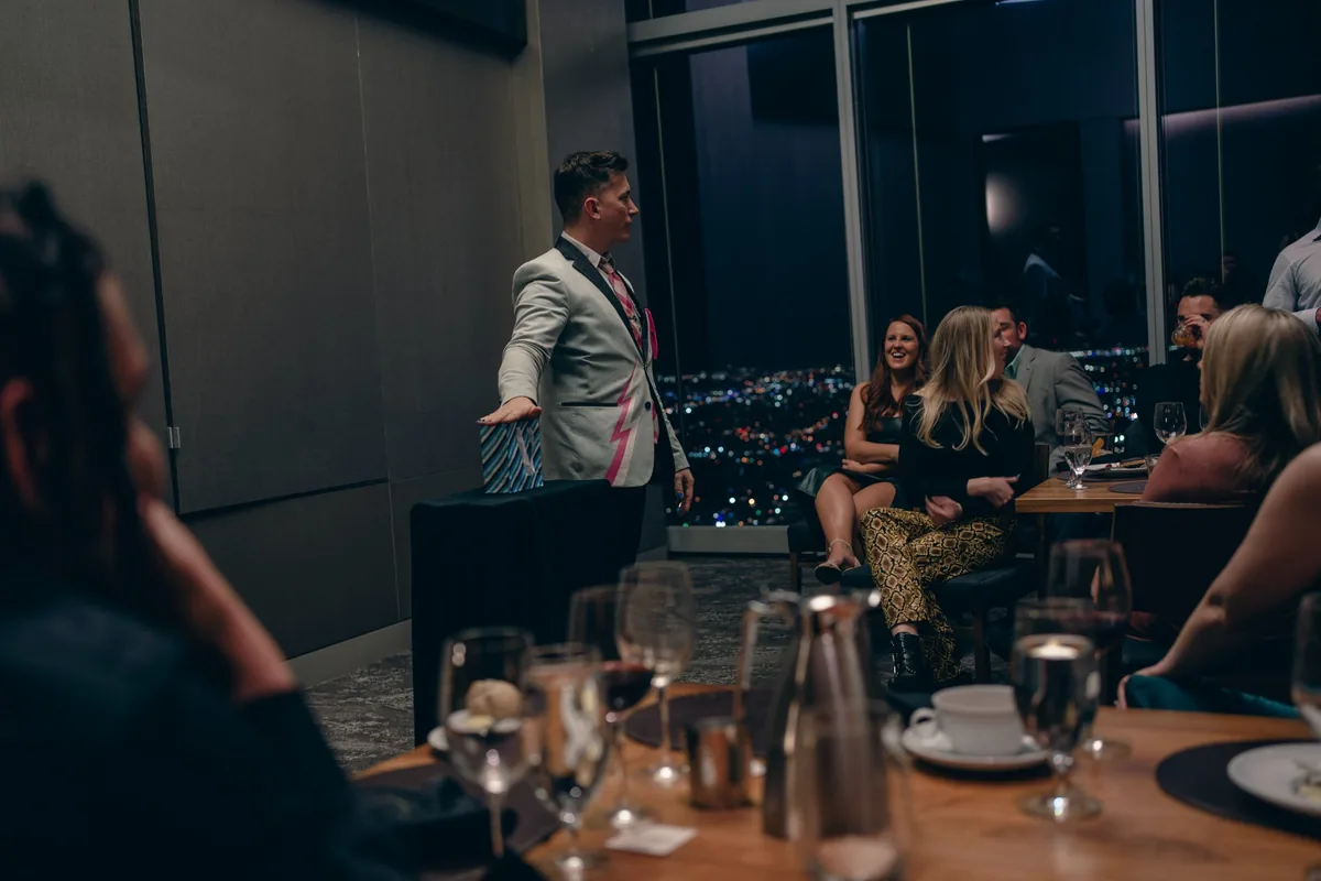 Joe Coover on stage pointing at audience