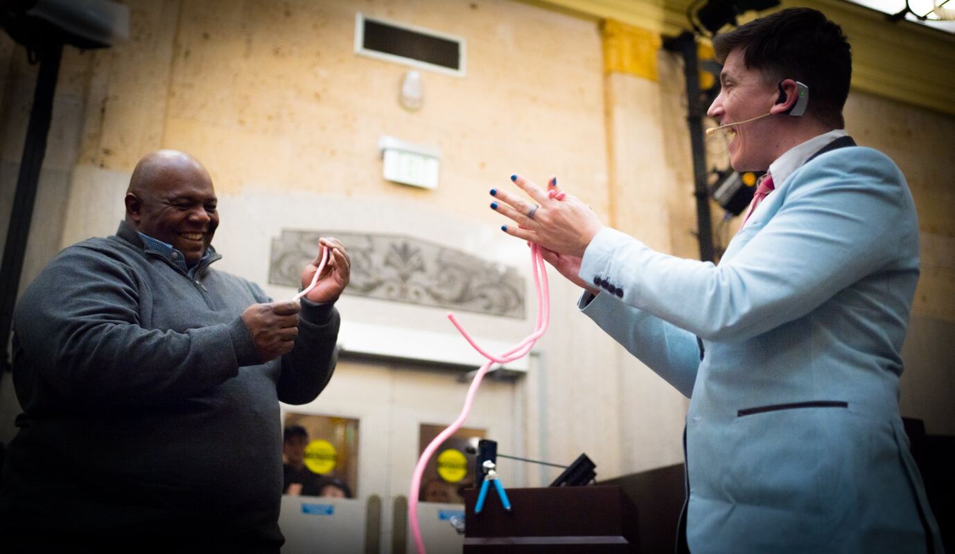 Joe Coover performing on stage at a corporate event